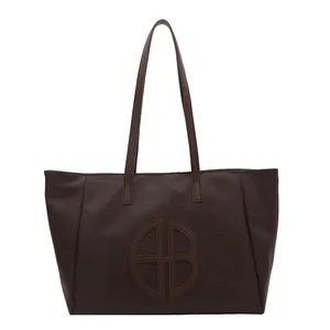 Large dark brown tote bag with AB logo and pebbled faux leather texture for women