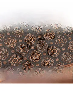 Macro view of water-resistant vintage floral PU leather fabric on crossbody bucket bag