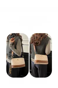 Detail of printed shell bag with wide shoulder strap and vintage floral patterns