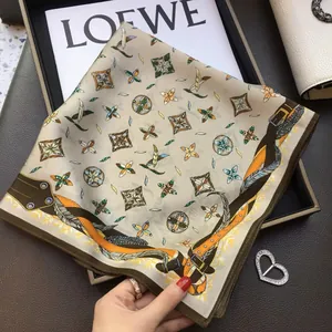 Elegant beige silk square scarf featuring geometric patterns and brown border detail