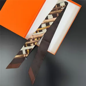 Elegant silk twilly scarf with bamboo pattern on premium orange gift box background