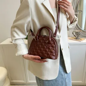 Deep brown quilted leather shell bag with top handles and adjustable shoulder strap