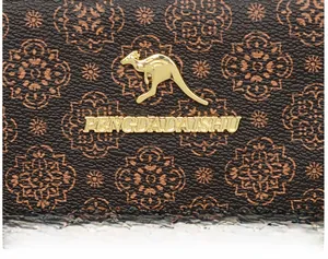 Macro shot of gold kangaroo logo and brand lettering on brown patterned leather surface