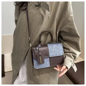 Close-up of contrast stitching and mixed blue texture on a brown square handbag