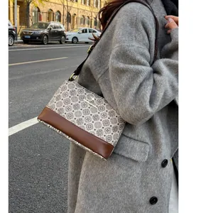 Vintage floral crossbody bag for women with leather trim and kangaroo metal logo accent
