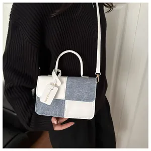 Detail of blue and white patchwork crossbody bag with Fashion Bags tag and shoulder strap