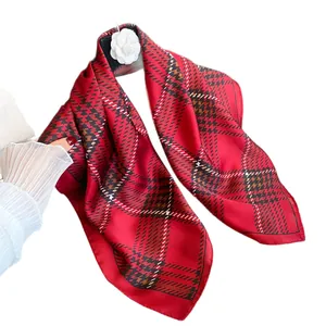 Classic red plaid silk scarf for women styled with camellia and a quilted luxury bag
