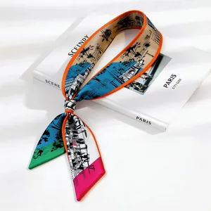 Slim French city sketch print silk twilly scarf tied on a Paris guide book