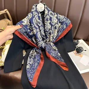 Close-up of navy paisley satin scarf tied on black dress with classic pattern details