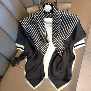 Detailed view of striped satin silk scarf with elegant black and white pattern