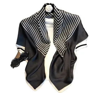 Classic black and white silk satin scarf with V-stripe pattern and elegant drape