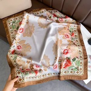 Close-up of satin silk scarf featuring realistic rose prints and wave patterns