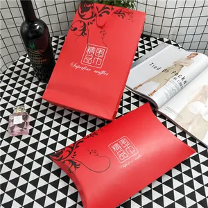 Detail view of premium red scarf gift bag and box set on a stylish checkered background