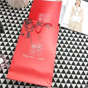 Macro shot of red paper gift bag with black floral vine pattern for scarves
