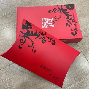 Detail of red luxury gift box set with elegant black vine pattern and carry handles