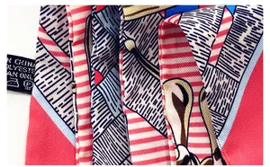 Macro detail of twill fabric silk scarf showing 100% polyester care label and stripes