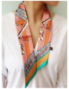 Detail view of equestrian pattern twilly scarf styled as a wrist accessory for women