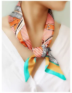 Close-up of narrow silk-feel scarf with equestrian prints and washing instruction tag