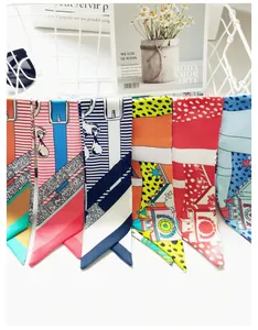 Assorted silk-like skinny scarves with geometric and animal prints in vibrant colors