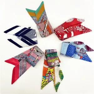 Flat lay of six colorful fashion silk scarves with geometric and floral artistic patterns