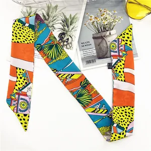Detail of printed twilly silk scarf with palm tree and leopard patterns on 100% polyester