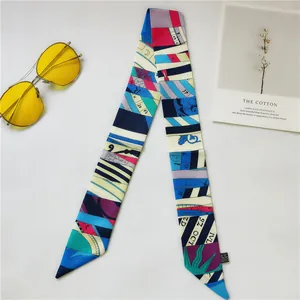 Detail of multi-color geometric silk scarf with letter print and yellow sunglasses