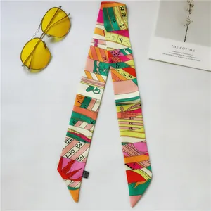 Detail of colorful silk scarf twilly with retro geometric patterns and letter prints