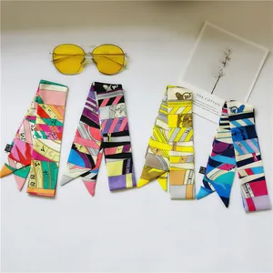 Detailed macro view of vibrant silk twilly scarves featuring artistic geometric patterns