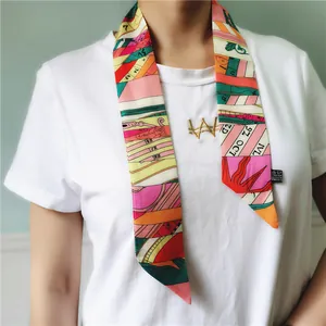 Colorful silk-like neck scarf with letter print styled on a white T-shirt for women