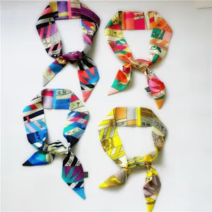 Set of four colorful silk-like twilly scarves with geometric patterns and letter prints