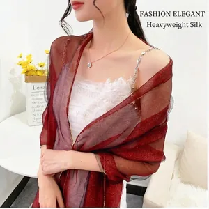 Close-up of elegant burgundy silk wool scarf featuring sparkling rhinestones and gold thread