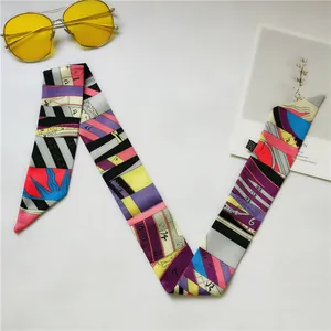 Elegant multicolored geometric print silk twilly scarf styled with aviator sunglasses