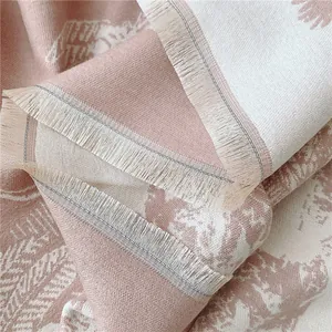 Détail de l'écharpe douce avec motifs de feuilles et finitions à franges soignées