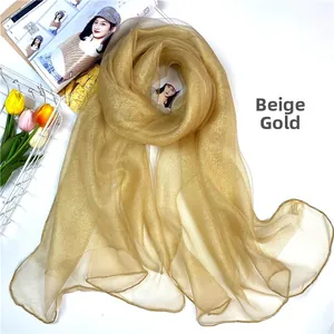 Close-up of champagne silk wool scarf with sparkling rhinestone detail and delicate texture