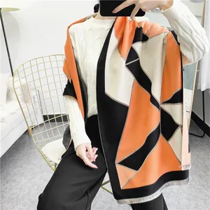 Close-up of geometric color block scarf featuring premium tassels and soft cashmere feel