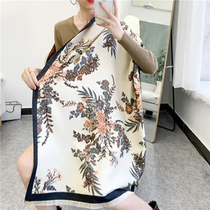 Detailed view of winter floral scarf with elegant fringe and cashmere feel texture