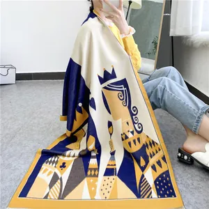 Macro detail of thick Queen card print scarf with yellow and blue decorative patterns