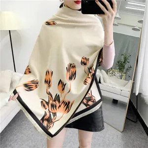 Detail of tulip floral print on elegant beige pashmina shawl with tassel edges