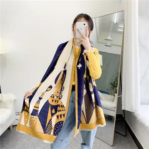 Detail of navy blue and yellow poker spade patterned scarf with soft fringe edges