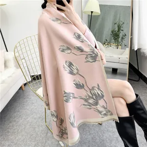 Detail of pink tulip print cashmere scarf with fine fringe trim and soft thick texture