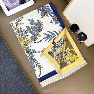 Detail of floral cashmere-like winter scarf showing delicate fringe and soft texture