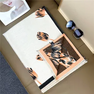 Detailed close-up of tulip floral pattern and fringe edge on cashmere-feel shawl