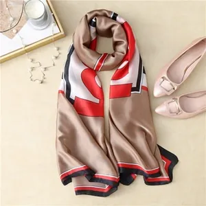 Macro view of silky champagne scarf with bold geometric color blocks and stripes