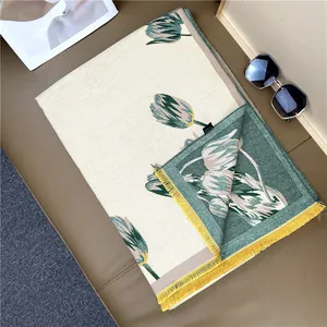 Detail of tulip cashmere scarf showing reversible colors and yellow tassel edges