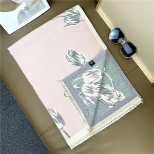 Close-up of soft cashmere-like shawl with elegant tulip prints and quality care label