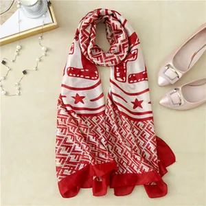 Detail of red and cream silk scarf with F-pattern, pearl necklace, and elegant flats