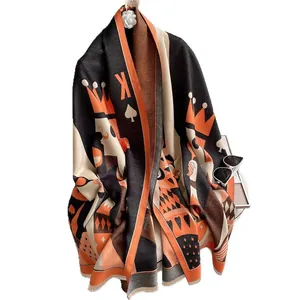 Thick warm winter scarf with Spade K poker pattern and orange tassel fringe detail