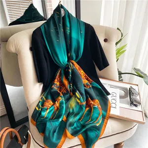 Close-up of silk scarf with forest deer print and orange hem on a black top