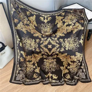 Luxurious black and gold silk shawl with baroque patterns draped on a grey chair