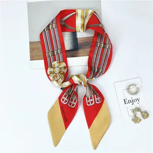 Close-up of red French vintage silk scarf with gold patterns and France Paris print